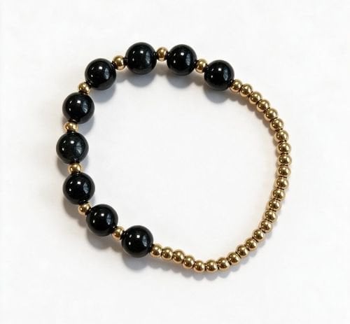 Dames armband Onyx 8 mm met RVS goudkleurige kralen