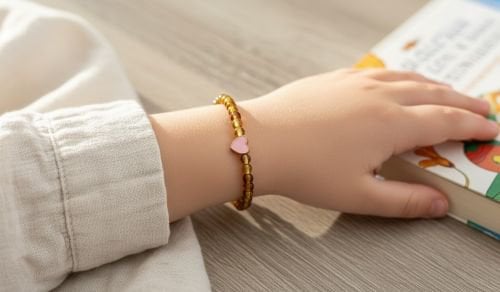 Kinderarmband natuursteen Amber 4 mm met hartje (16 cm)